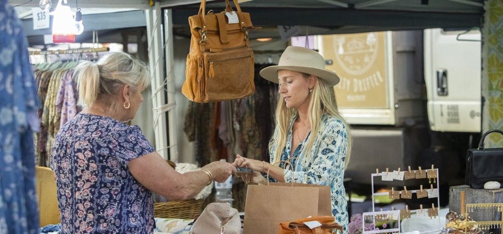 Image of stallholder assisting customer